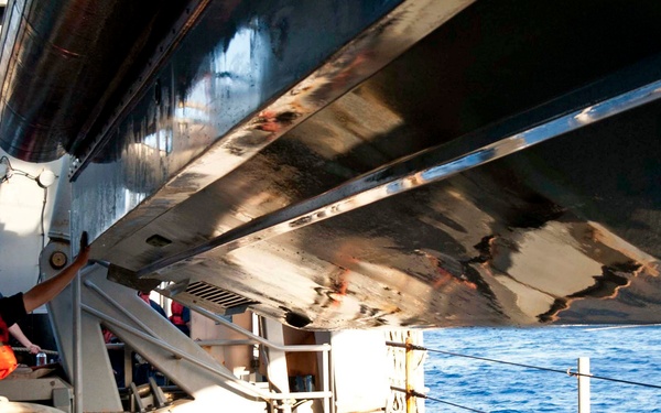 USS Fort McHenry sailor guides boat