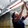 USS Carl Vinson sailor tightens fixture USS Carl Vinson sailor tightens fixture