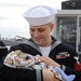 USS Norfolk sailor holds his newborn for first time