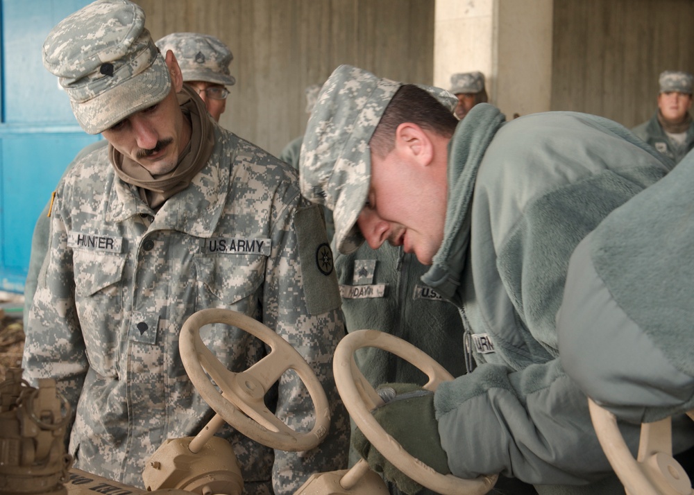 Soldiers Work to clear high school of flooding