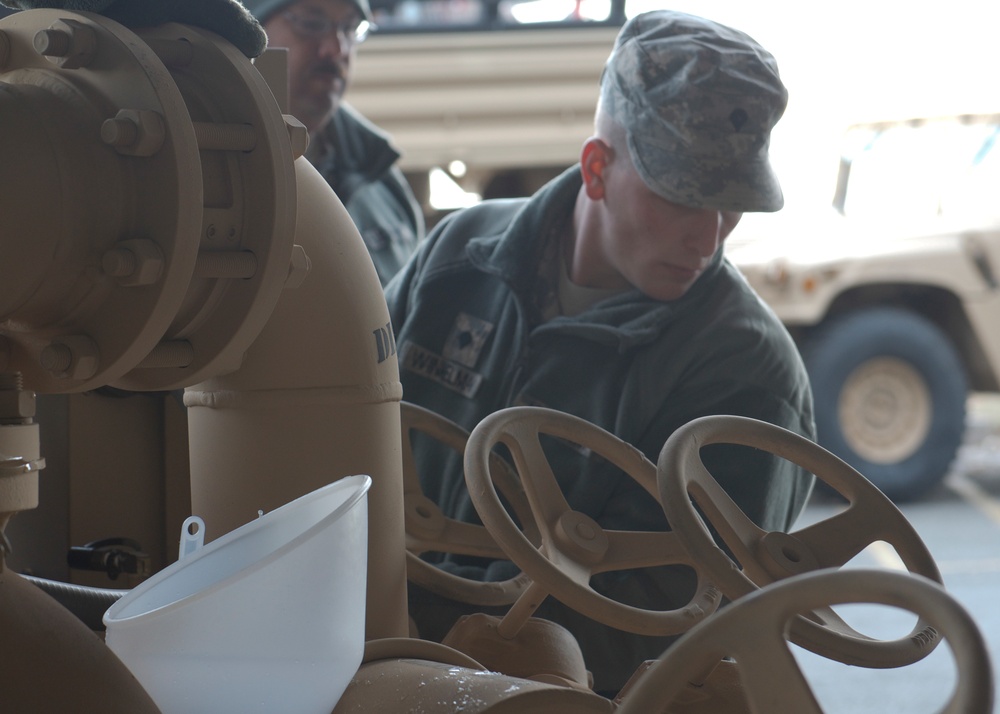 Soldiers work to clear high school of flooding