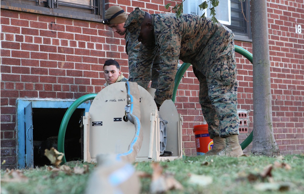 Marines help with hurricane relief by pumping water from apartments