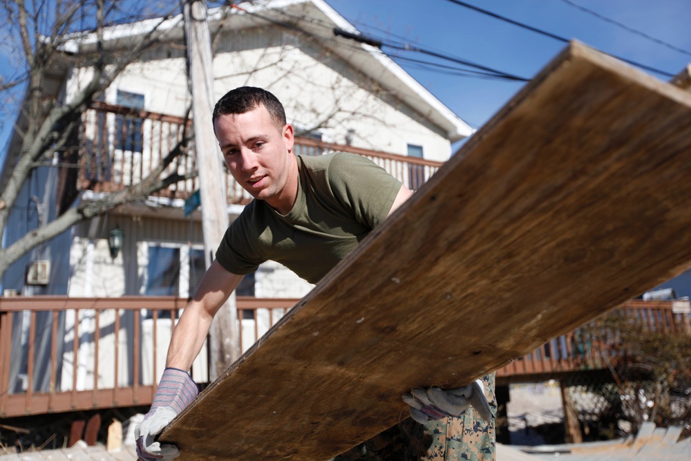 Marines move debris after Hurricane Sandy