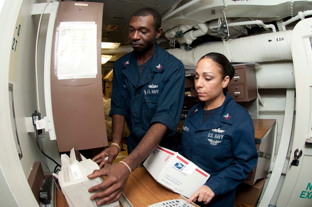 USS Hue City sailors process mail