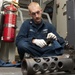 USS Hue City sailor cleans gun