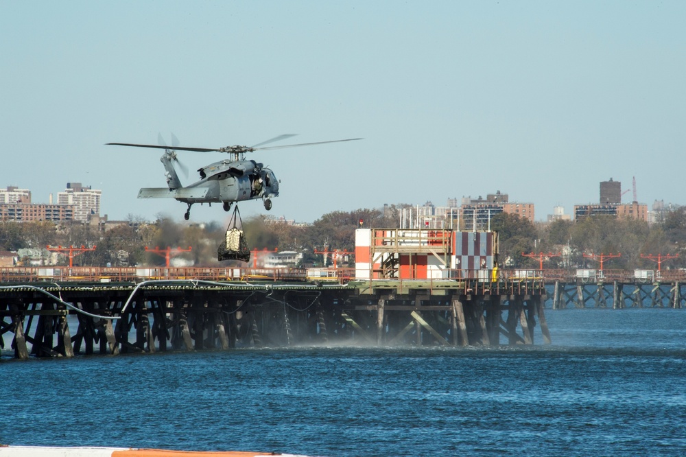 MH-60S Sea Hawk sling loads a power generator