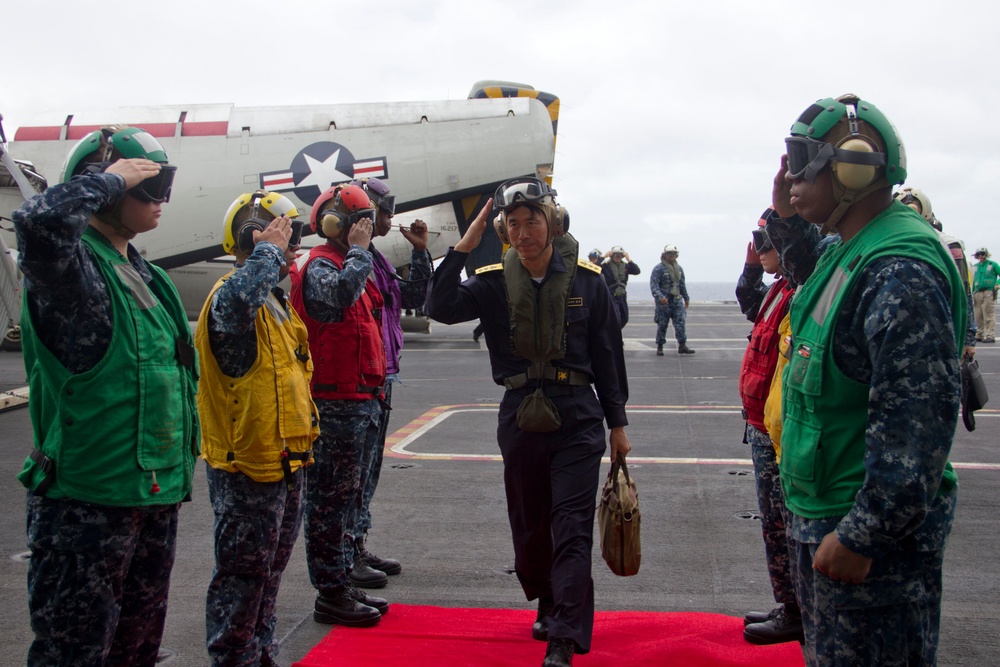 Japanese commander walks through USS George Washington sideboys