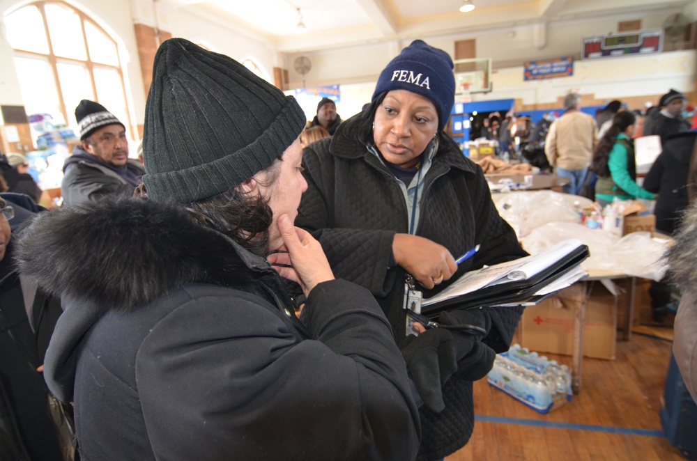 FEMA Community Relations employees explain to Rockaway, New York residents about applying for Federal aid