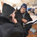 FEMA Community Relations employees explain to Rockaway, New York residents about applying for Federal aid