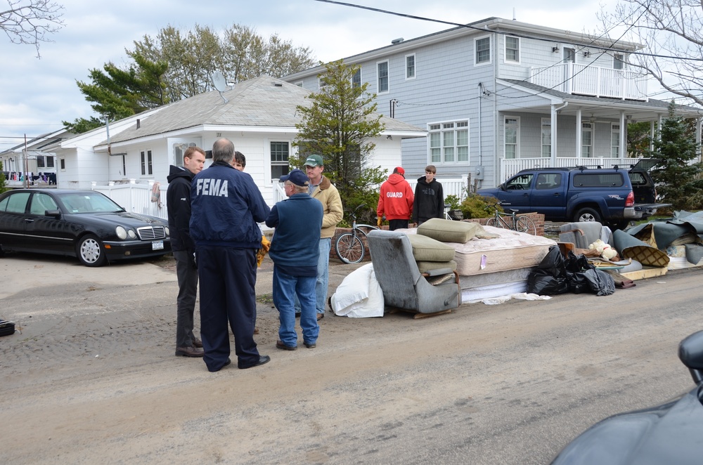 FEMA Community Relations workers go door to door in storm ravaged Rockaway, New York area of  Breezy Point