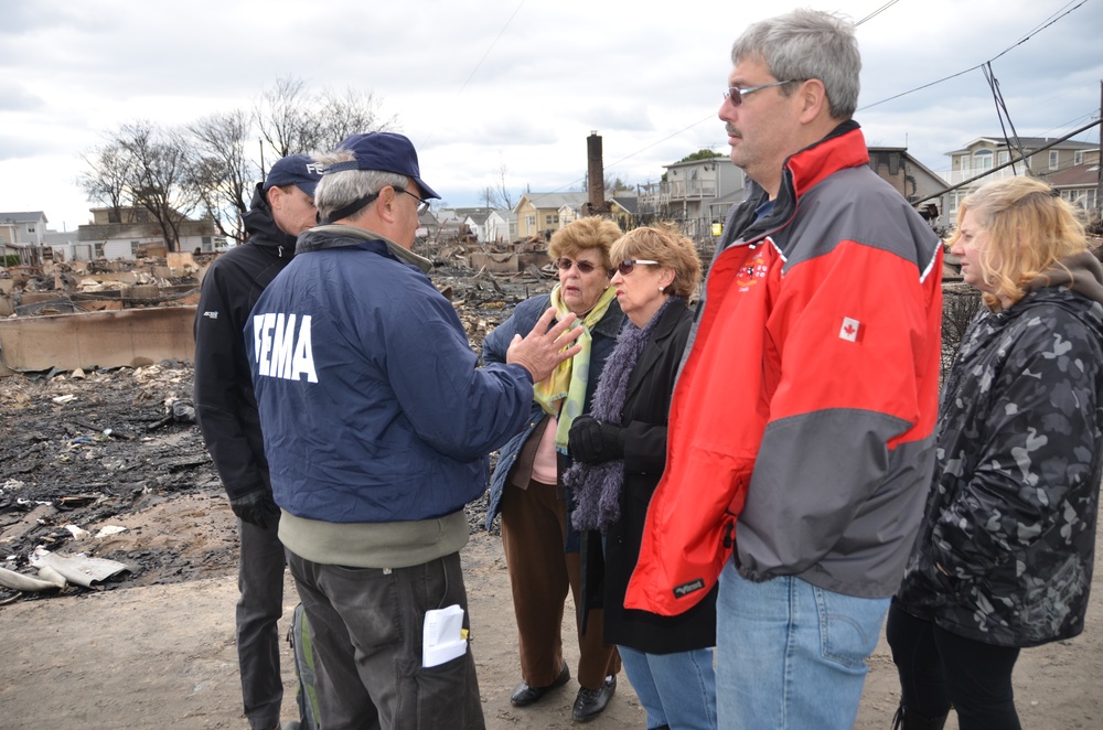 Disaster residents receive federal aid information from FEMA community relations workers