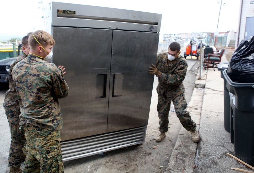 Marines move a large appliance
