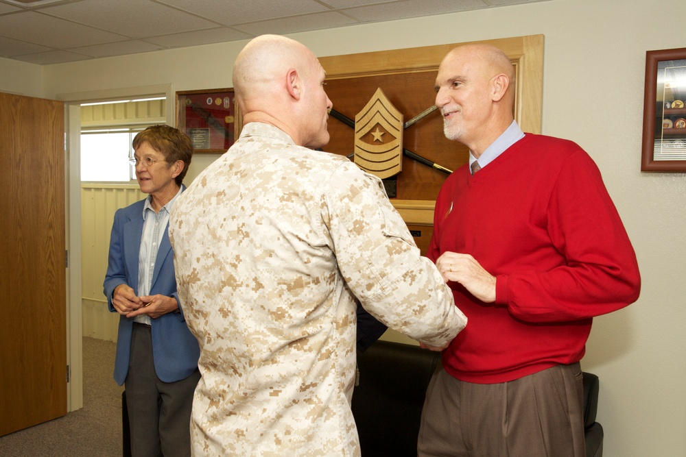 Sgt. Maj. of the Marine Corps Micheal P. Barrett greets a civilian employee