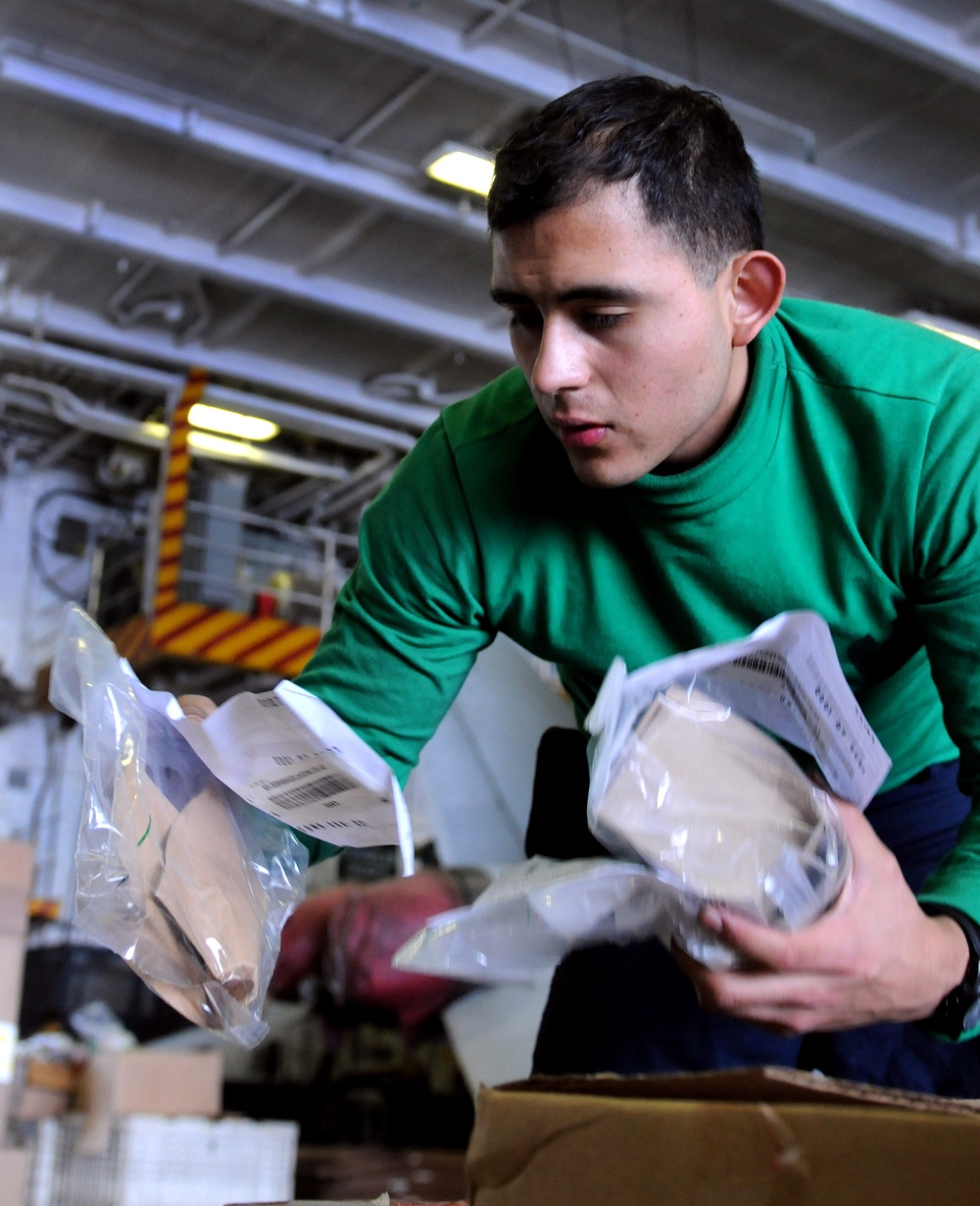 USS Nimitz crew sorts packages