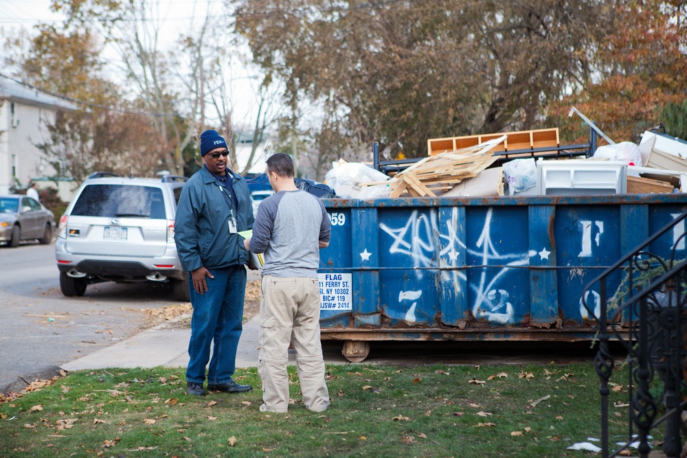 FEMA Community Relations Specialists help as residents clean up