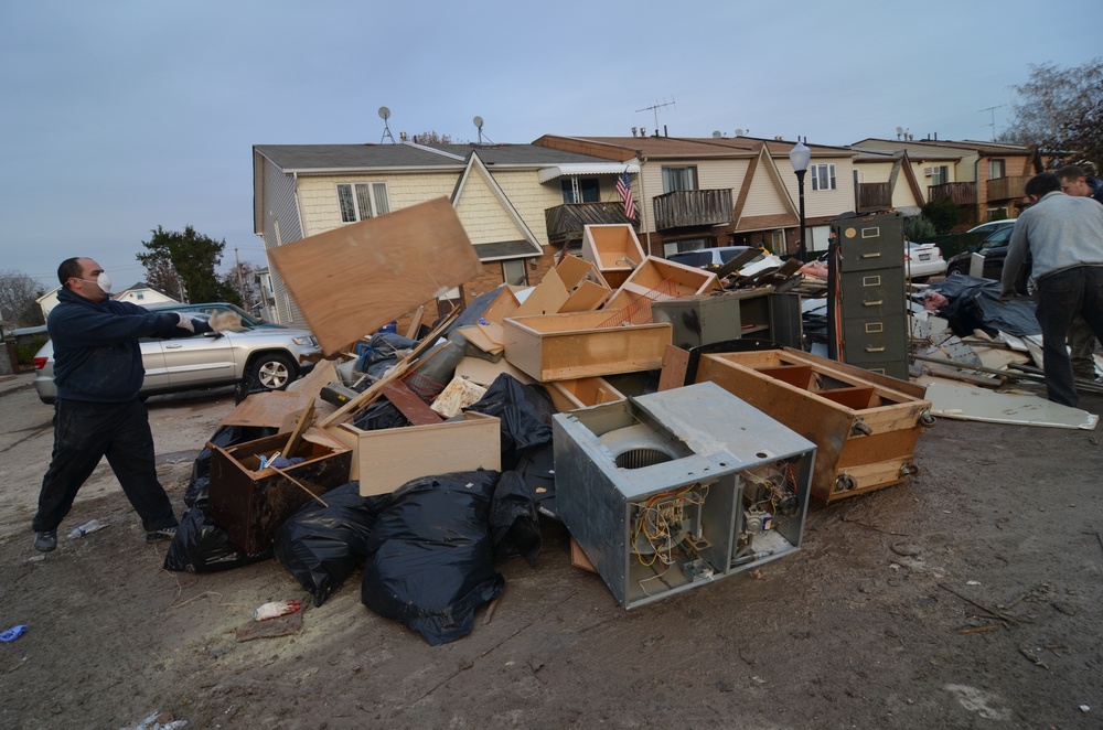 Residents of Midland Beach on Staten Island rid homes of water-soaked furniture