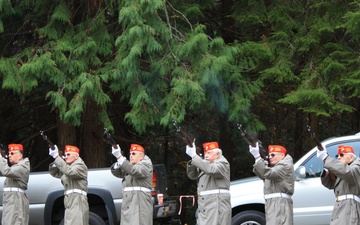 The Honor Guard from Gardiner, Washington fires a 21-gun salute