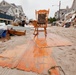 A rocking chair sits amidst debris piled up outside of homes in Long Beach, N.Y.