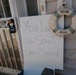 A sign warning looters to 'beware' is posted on the front door of a flooded home in Long Beach, NY