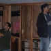 Workmen remove hazardous flood material