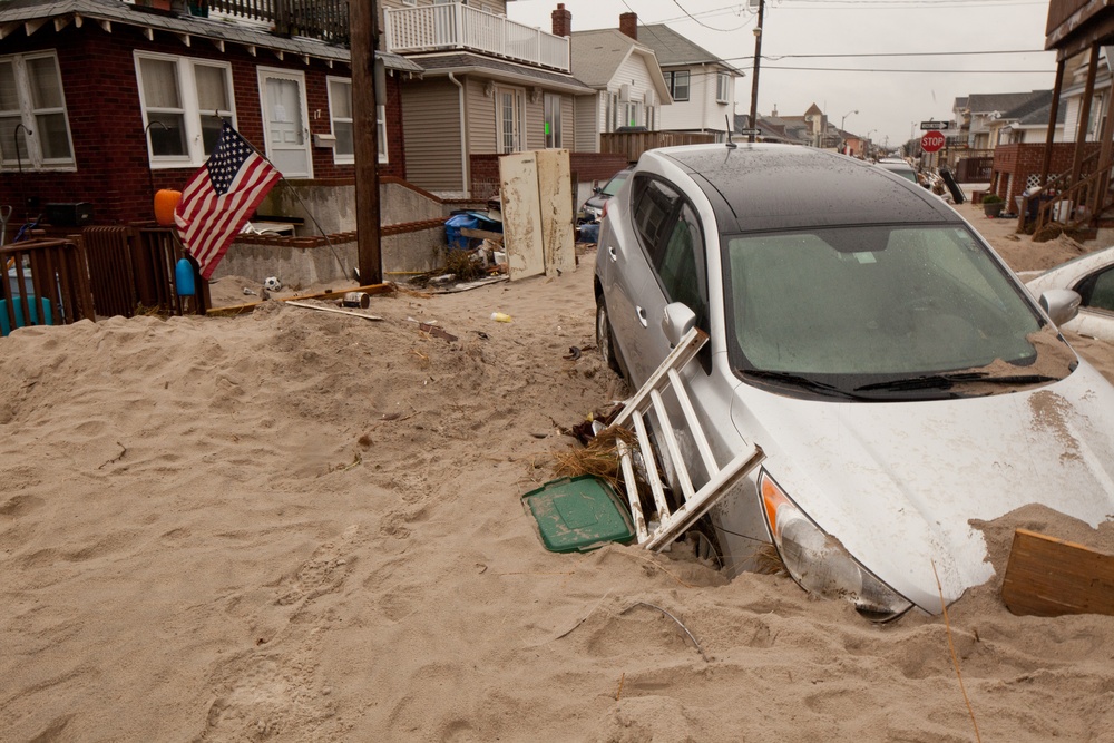 Cars and debris piled up outside of homes in Long Beach, NY