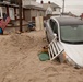 Cars and debris piled up outside of homes in Long Beach, NY