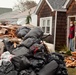 Hurricane Sandy survivor stands on the porch of his flooded home in Long Beach, NY