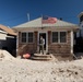 Hurricane Sandy survivor stands on the porch of his flooded home in Long Beach, N.Y.