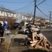 Survivors remove destroyed possessions