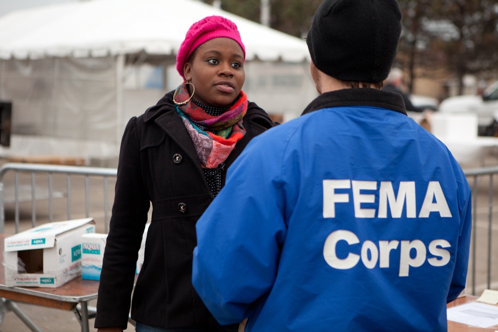 FEMA Corps listens to disaster survivor at the FEMA Disaster Recovery Center in Far Rockaway, New York.