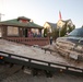 Vehicle destroyed by Hurricane Sandy storm surge is removed by tow trailer from Long Beach, New York.