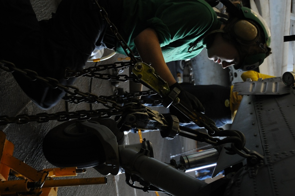USS Nimitz sailors perform helicopter maintenance