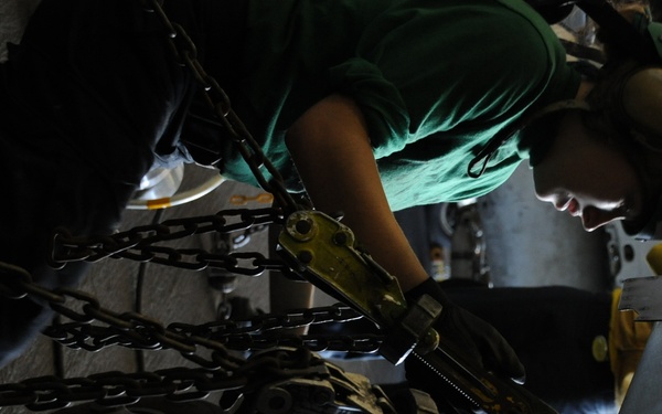 USS Nimitz sailors perform helicopter maintenance