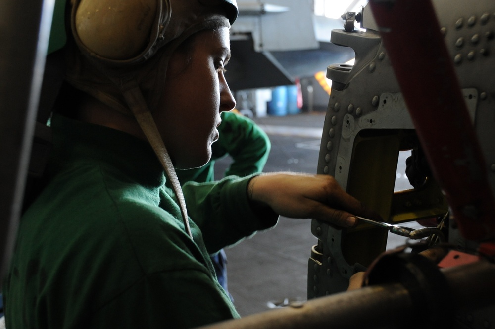 USS Nimitz sailors perform helicopter maintenance