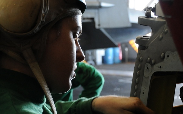 USS Nimitz sailors perform helicopter maintenance