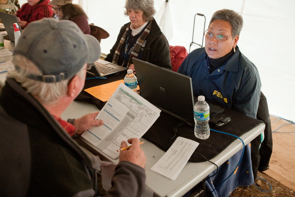 FEMA Disaster Recovery specialist assists Hurricane Sandy survivor at a FEMA/State Disaster Recovery Center