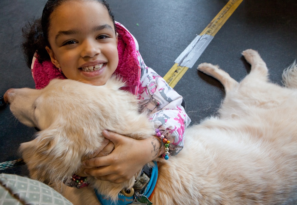Comfort Dog provides support to a disaster survivor at a FEMA Recovery Center in Long Beach, NY