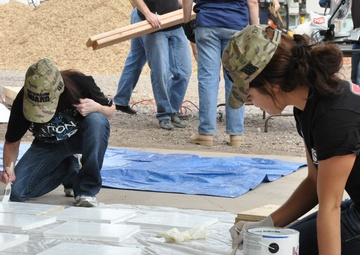 Guard members support community, help build playground
