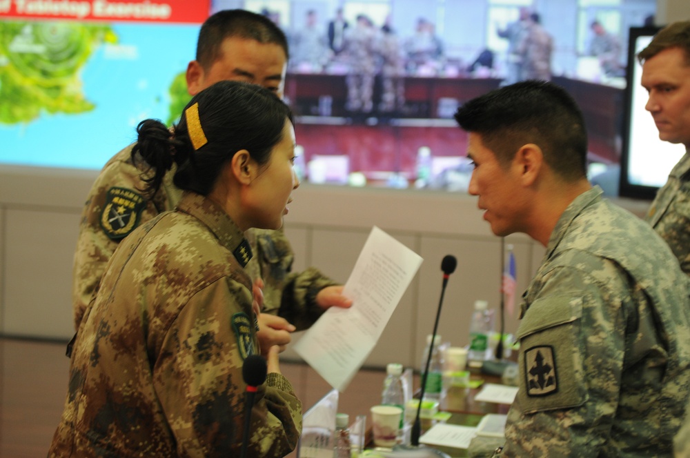 Lt. Col. Mitsuyoshi works with his PLA counterpart