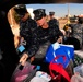 USS Theodore Roosevelt sailors provide Christmas presents to needy children