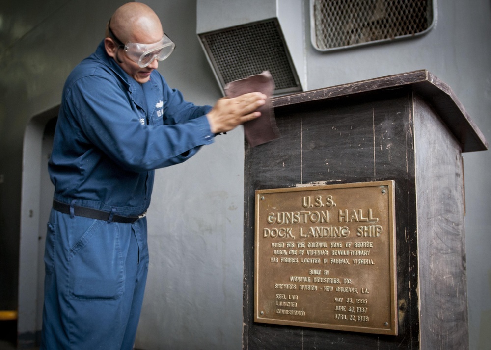 USS Gunson Hall sailor works on podium