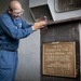 USS Gunson Hall sailor works on podium