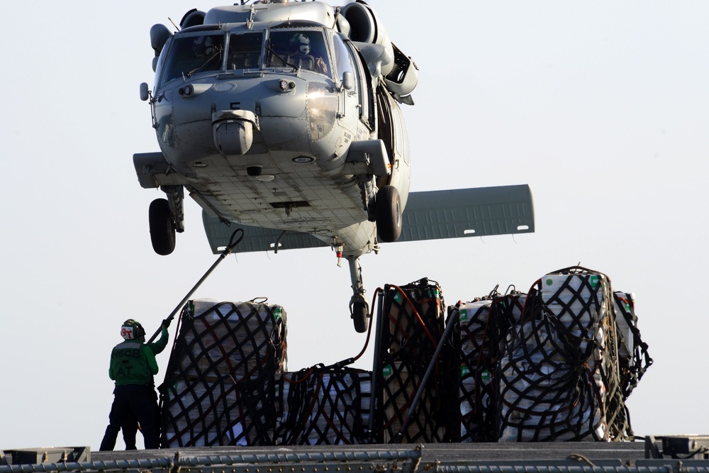 MH-60S Sea Hawk tranports items during USS John C. Stennis