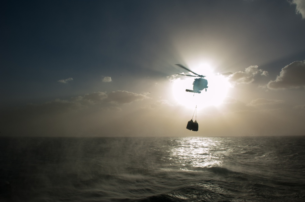 MH-60S Knight Hawk carries supplies to USS Mobile Bay