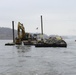 Equipment removing rock on the Mississippi River