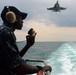 USS John C. Stennis sailor stands aft lookout watch