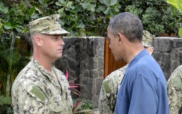 President Barack Obama shakes the hand of Senior Chief Builder James Dolan