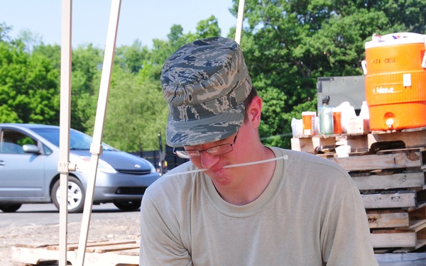 171st unit members fill sandbags in 90-degree temperatures