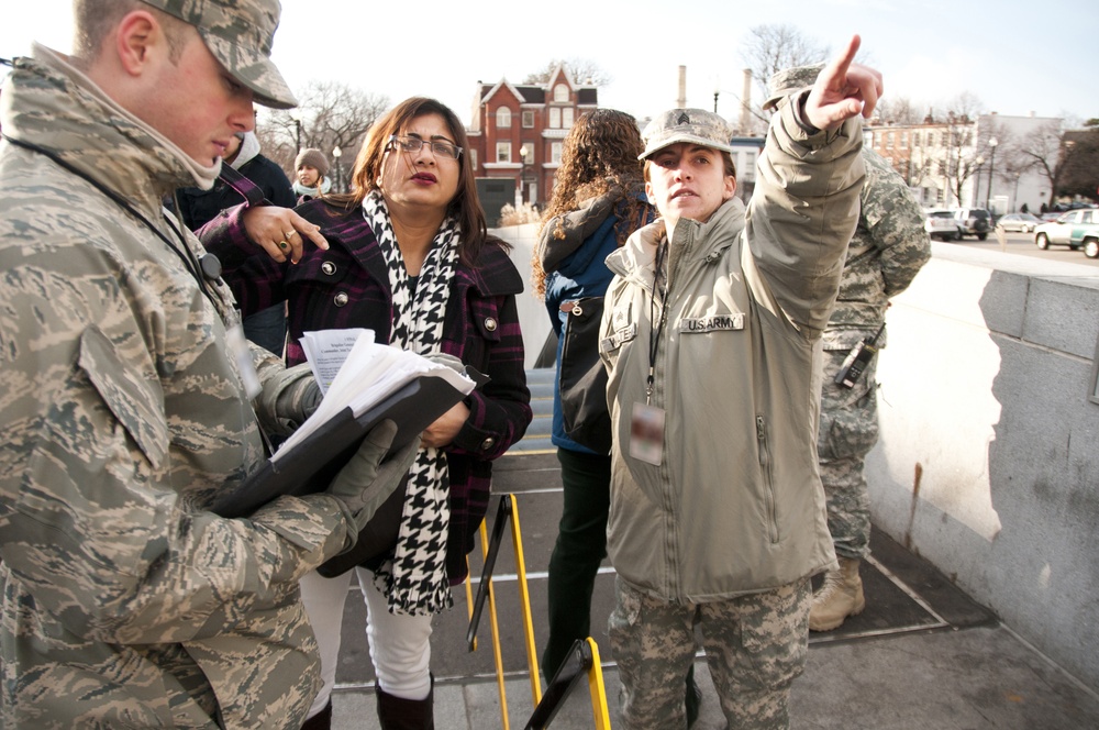 Sgt. Sara Walter from 253rd Military Police Company in Tennessee helps an inauguration attendee