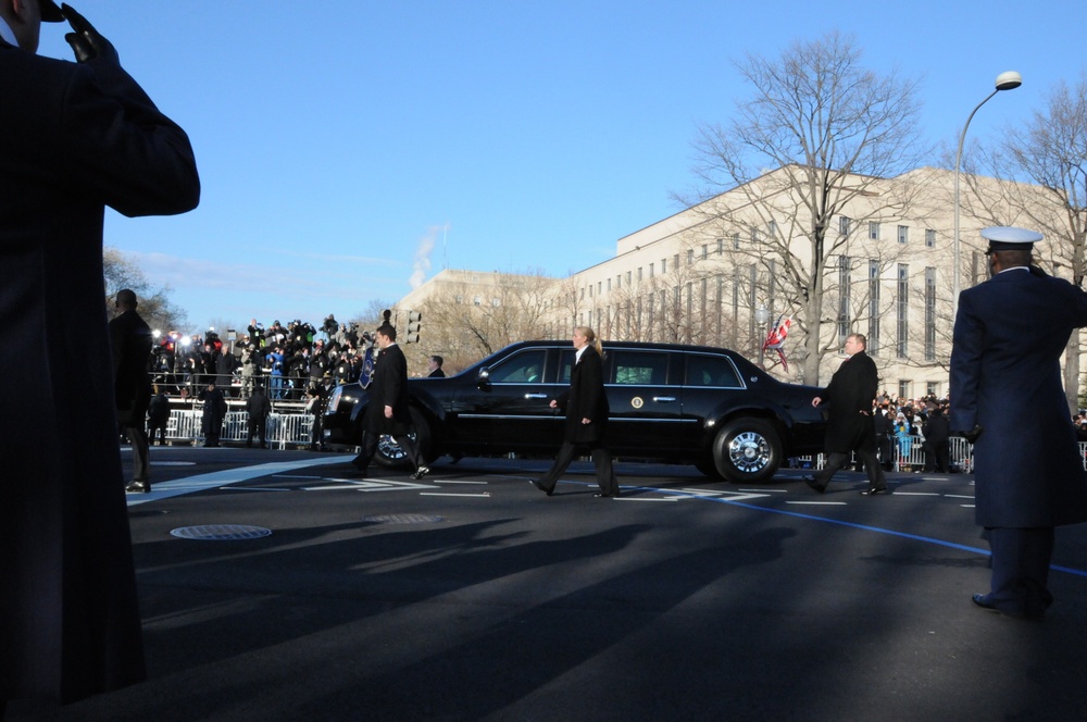 Air Force service members salute President Barack Obama as he drives by in the inaugural parade